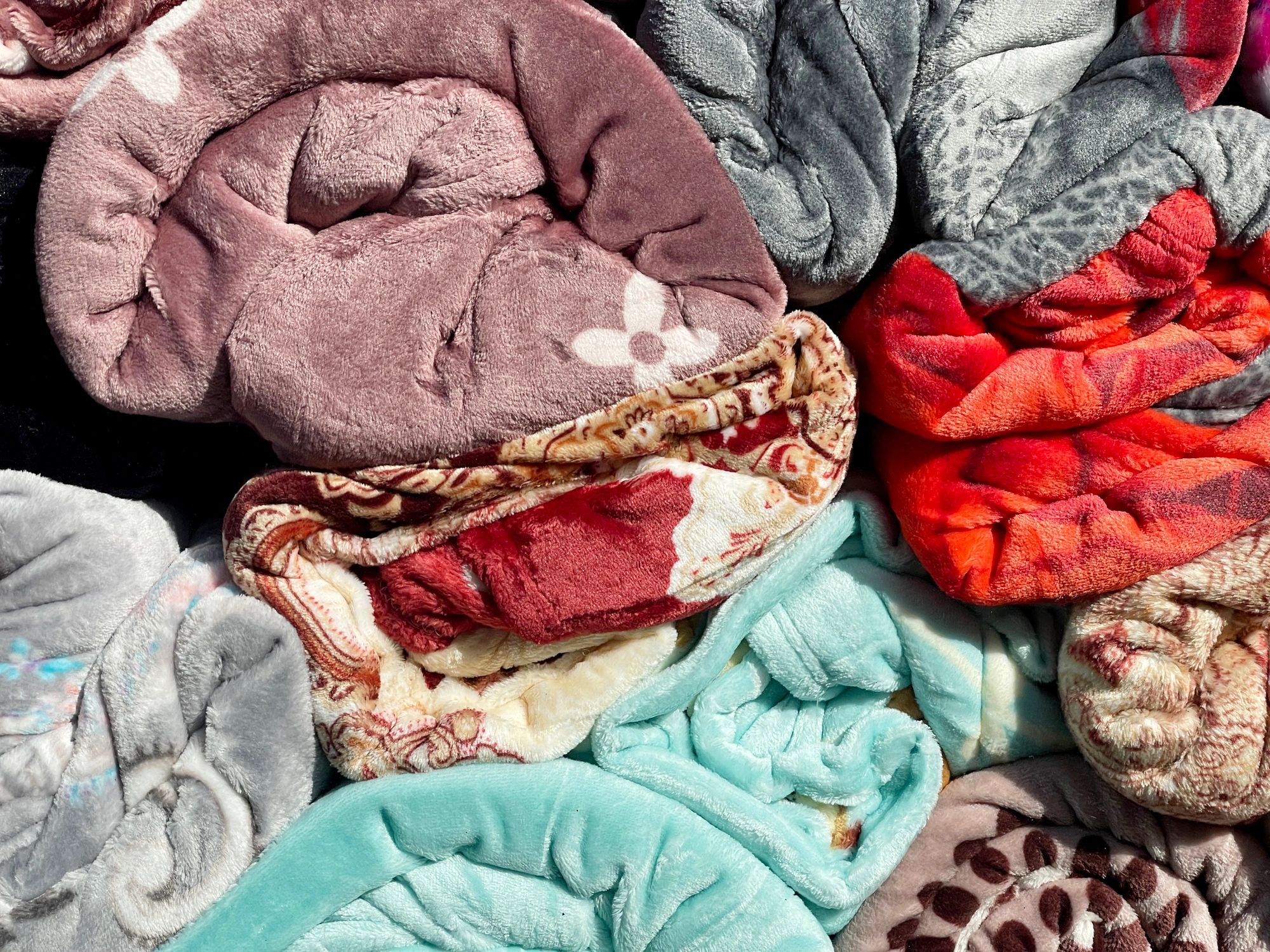 Colorful blankets displayed in a retail setting