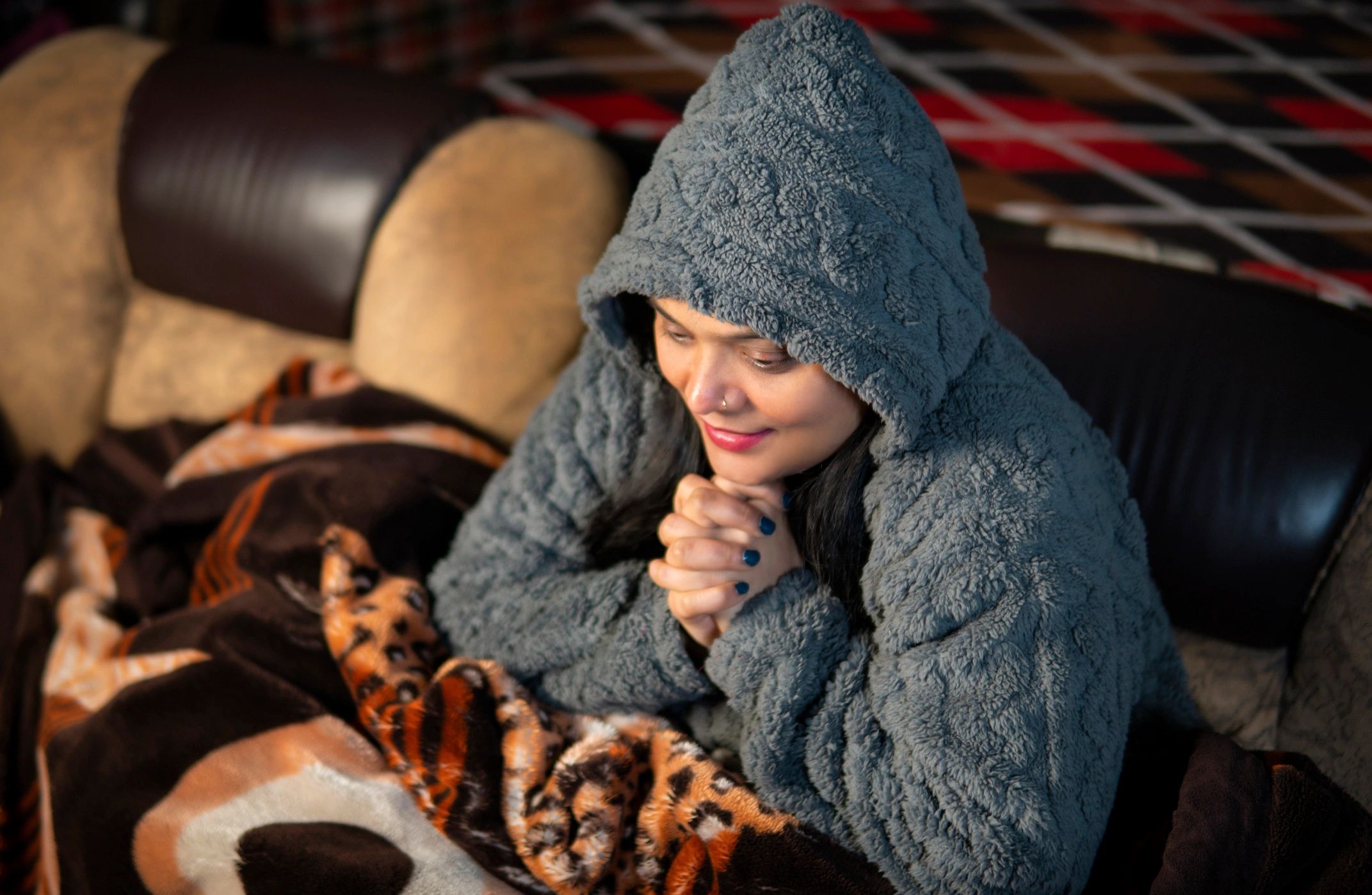 Customer enjoying warmth and comfort with a blanket at home