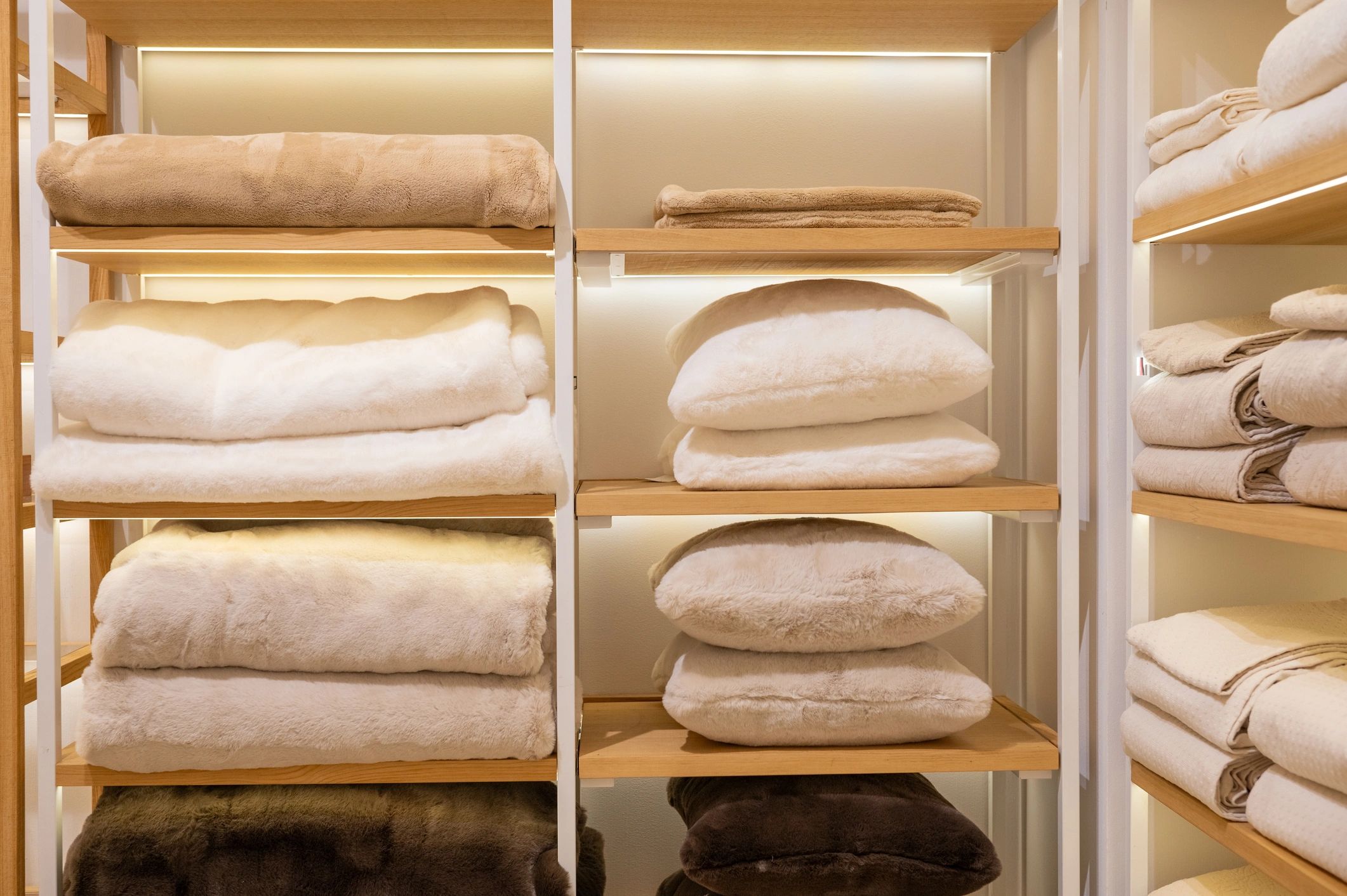 Neatly folded premium blankets on organized shelves